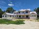 New construction home featuring a modern elevation, large windows, and a covered front porch at 405 Long And Winding Rd, Howey In The Hills, FL 34737