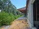 New construction home featuring a modern elevation, large windows, and a covered back porch at 405 Long And Winding Rd, Howey In The Hills, FL 34737