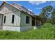 New construction home featuring a modern elevation, large windows, and a covered back porch at 405 Long And Winding Rd, Howey In The Hills, FL 34737