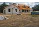 New construction home with block construction and a dumpster on the property at 405 Long And Winding Rd, Howey In The Hills, FL 34737