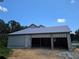New construction three-car garage with a modern elevation, ready for your vehicles at 405 Long And Winding Rd, Howey In The Hills, FL 34737