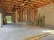 Expansive garage showcasing the framing stage, with wooden beams and concrete flooring, offering ample space at 405 Long And Winding Rd, Howey In The Hills, FL 34737