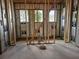 Framed walls and windows in an unfinished interior space, ready for plumbing and electrical work, offering customization at 405 Long And Winding Rd, Howey In The Hills, FL 34737