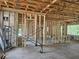 Interior view under construction, featuring wooden framing and concrete floors ready for customization and finishing touches at 405 Long And Winding Rd, Howey In The Hills, FL 34737