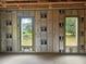 Partially constructed interior featuring two windows with views of the neighborhood, insulated walls, ready for personalization at 405 Long And Winding Rd, Howey In The Hills, FL 34737