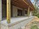 Covered back porch featuring sturdy wooden support columns at 405 Long And Winding Rd, Howey In The Hills, FL 34737