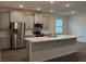 Modern kitchen with stainless steel appliances and island at 300 Barebow Ln, Ormond Beach, FL 32174