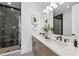 Modern bathroom with dual sinks, marble countertops, and a walk-in shower with glass enclosure at 2110 Whitney Marsh Aly, Orlando, FL 32804