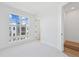 Sunlit bedroom with a large window offering neighborhood views, neutral carpet, and white trim, showcasing a cozy space at 2110 Whitney Marsh Aly, Orlando, FL 32804