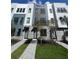 Stylish modern townhome exterior with gray brick accents, offering a sleek and contemporary design at 2110 Whitney Marsh Aly, Orlando, FL 32804