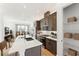 Contemporary kitchen features dark wood cabinets, quartz countertops, and stainless steel appliances at 2110 Whitney Marsh Aly, Orlando, FL 32804