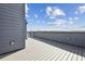 Wide rooftop deck featuring a scenic view, wood-look decking, and a modern metal railing for outdoor relaxation at 2110 Whitney Marsh Aly, Orlando, FL 32804