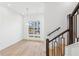 Bright staircase with wooden and black metal banister, next to a dining space with modern light fixture at 2110 Whitney Marsh Aly, Orlando, FL 32804