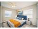 This bedroom features a blue headboard, neutral walls, white nightstands and a ceiling fan for comfort at 507 Francis Blvd, Lakeland, FL 33801