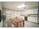Bright kitchen features white cabinets, modern appliances, granite countertops, and light gray wood-look floors at 507 Francis Blvd, Lakeland, FL 33801