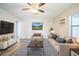 The living room is a relaxing area with a sofa, chair, a contemporary ceiling fan, and light wood floors at 507 Francis Blvd, Lakeland, FL 33801
