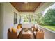 Cozy screened-in porch with ample seating, an exposed wood ceiling, and views of the landscaped yard at 507 Francis Blvd, Lakeland, FL 33801
