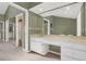 Bathroom featuring a white vanity with tons of storage space and lots of mirrors and open doorway to other rooms at 51 Oakleigh Ln, Maitland, FL 32751