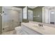 Bathroom features a glass-enclosed shower, safety bars, a white vanity, and a large mirror at 51 Oakleigh Ln, Maitland, FL 32751