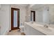 Bathroom with a double sink vanity, a soaking tub and door to the back yard at 51 Oakleigh Ln, Maitland, FL 32751
