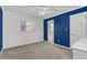 Carpeted bedroom with a window, blue accent wall, ceiling fan, and white trim at 51 Oakleigh Ln, Maitland, FL 32751