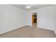 Empty bedroom has carpet floors, white walls, and view to a kitchen at 51 Oakleigh Ln, Maitland, FL 32751