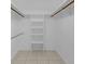 Spacious walk-in closet with ample shelving and hanging rods, providing plenty of storage, and tiled floors at 51 Oakleigh Ln, Maitland, FL 32751
