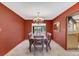 The dining room offers an elegant light fixture and a view of the backyard pool at 51 Oakleigh Ln, Maitland, FL 32751