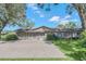 Charming single-story home featuring a brick driveway and well-manicured lawn, perfect for curb appeal at 51 Oakleigh Ln, Maitland, FL 32751