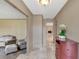 View of the home's neutral foyer, which features a marble tile floor and view to the living room with fireplace at 51 Oakleigh Ln, Maitland, FL 32751