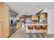 Spacious kitchen with stainless steel appliances, bar stool seating, light-colored wood cabinets, and tiled floors at 51 Oakleigh Ln, Maitland, FL 32751