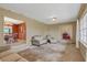 Open-concept living room with carpet flooring adjoins a formal dining room with a chandelier at 51 Oakleigh Ln, Maitland, FL 32751