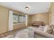 The expansive living room features plush carpet, comfortable seating, and a large window with natural lighting at 51 Oakleigh Ln, Maitland, FL 32751