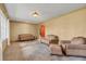 The expansive living room includes plush carpet, a ceiling light, and comfortable seating with natural lighting at 51 Oakleigh Ln, Maitland, FL 32751