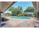 Backyard swimming pool with surrounding brick patio and lush tropical landscaping creating a private oasis at 51 Oakleigh Ln, Maitland, FL 32751