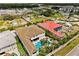 Aerial shot highlighting the backyard pool, waterfall features, outdoor amenities, and landscaping at 1021 Fantasy Dr, Davenport, FL 33896