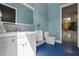 A modern bathroom features a sleek vanity, contemporary fixtures, and a glass-enclosed shower, providing a clean aesthetic at 1021 Fantasy Dr, Davenport, FL 33896