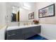 Bright bathroom featuring a double vanity with gold fixtures and a large framed mirror at 1021 Fantasy Dr, Davenport, FL 33896