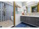 Stylish bathroom features star themed tile, modern vanity, and glass enclosed shower at 1021 Fantasy Dr, Davenport, FL 33896