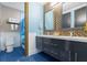 Stylish bathroom showcasing double vanity sinks with modern fixtures, toilet, and a luxurious tiled shower at 1021 Fantasy Dr, Davenport, FL 33896