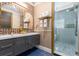 Elegant bathroom featuring a double sink vanity and a glass-enclosed shower for a spa-like experience at 1021 Fantasy Dr, Davenport, FL 33896
