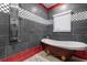 Modern bathroom showcasing a free-standing tub and a rainfall shower head with accent lighting at 1021 Fantasy Dr, Davenport, FL 33896