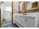 Bathroom boasts a double vanity with decorative mirrors and a soaking tub for relaxation at 1021 Fantasy Dr, Davenport, FL 33896