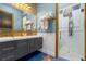 Modern bathroom features double vanity sinks, gold hardware, and a glass-enclosed shower at 1021 Fantasy Dr, Davenport, FL 33896