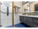 Modern bathroom boasts double vanity sinks, gold hardware, and glass-enclosed shower at 1021 Fantasy Dr, Davenport, FL 33896