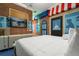 Themed bedroom features a brick wall, mounted tv, and queen size bed with white linens at 1021 Fantasy Dr, Davenport, FL 33896