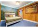 Themed bedroom showcasing a comfortable bed, tropical wall art, and inviting decor, creating an immersive experience at 1021 Fantasy Dr, Davenport, FL 33896