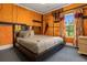 Modern bedroom with sleek bed frame, accent wall, and bright light from a window, creating a unique theme at 1021 Fantasy Dr, Davenport, FL 33896
