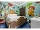 Themed bedroom with decorative bed, unique murals, and an airy atmosphere for inspired living at 1021 Fantasy Dr, Davenport, FL 33896