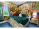 Unique bedroom featuring themed murals, a decorative bed and colorful accents for creative design at 1021 Fantasy Dr, Davenport, FL 33896